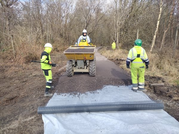 Construction company laying paths
